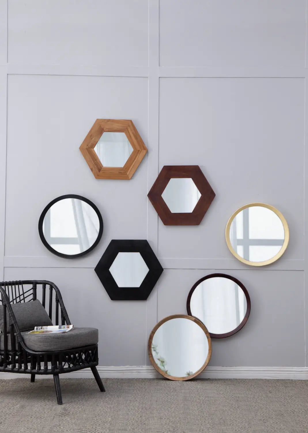 A collection of geometric mirrors in hexagonal and circular shapes featuring frames made from wood or metal in natural tones including light oak dark brown black and gold with a mango wood round wall mirror 20 inch dark bronze frame.