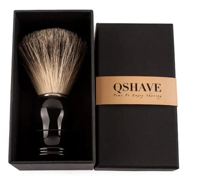 Black handled badger hair shaving brush with dense natural bristles in gradient beige to dark brown for shaving use.
