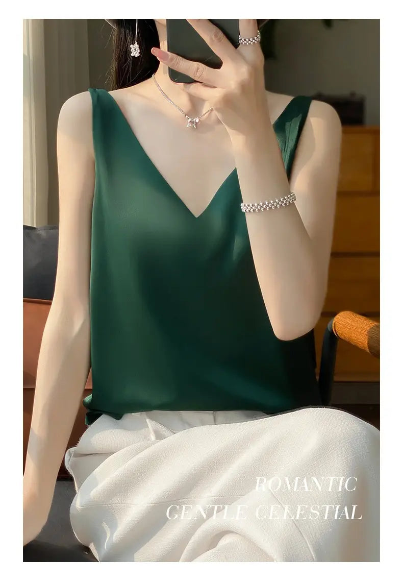 Deep emerald green silky satin sleeveless camisole top with a v-neckline.