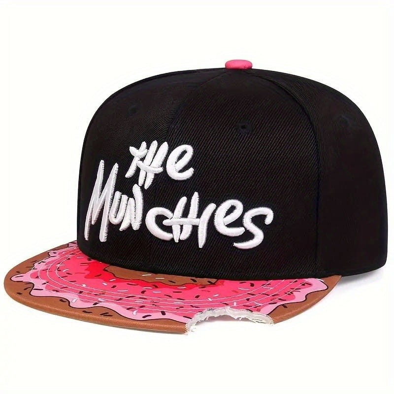 Black snapback cap with white embroidered the munchies text and a pink frosting donut design on the brim in the munchies embroidered flat brim snapback cap product.