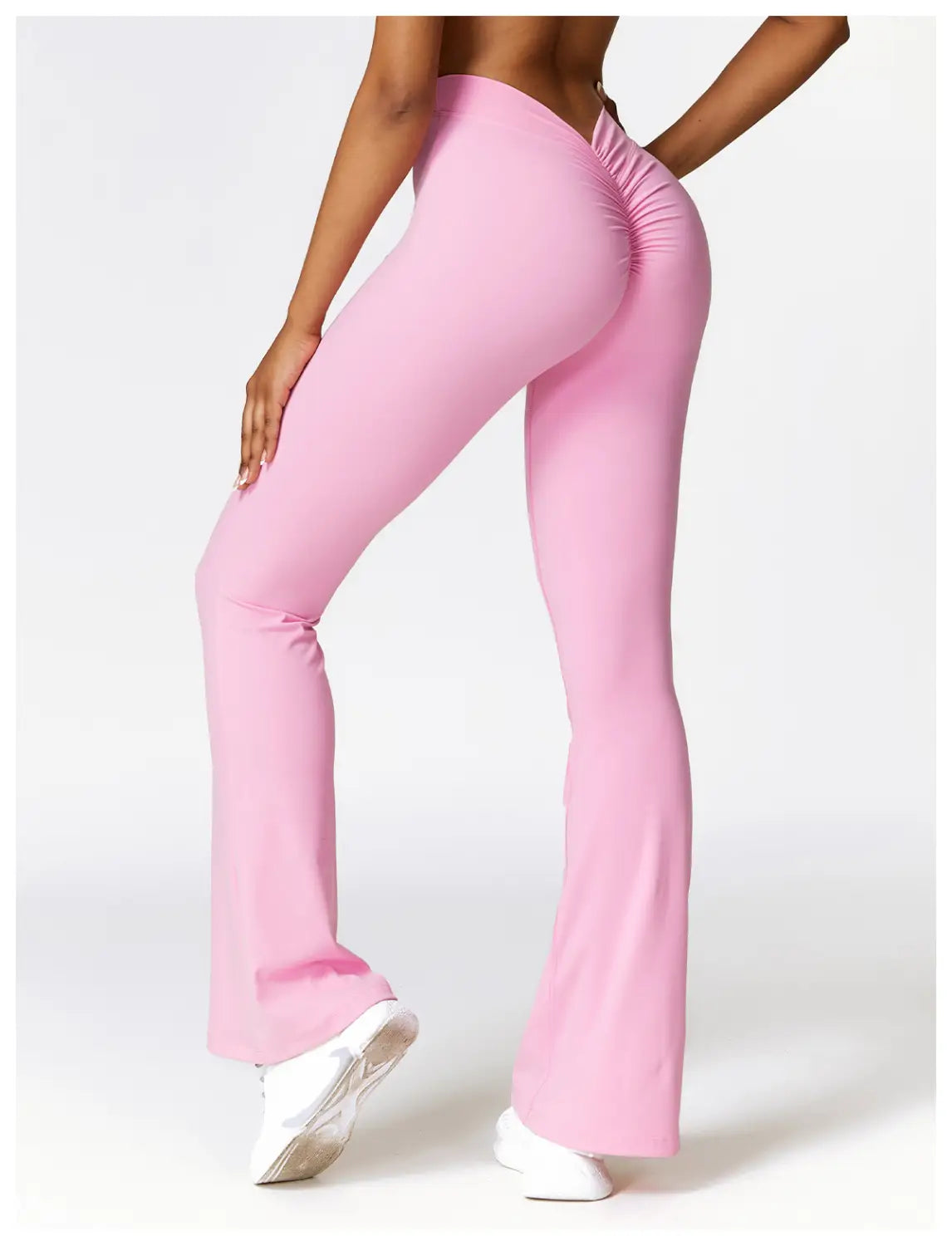 pink high-waist flared yoga pants with ruched back design made of stretch fabric for activewear use shown from the back side