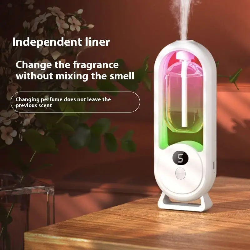 Digital aroma diffuser automatic air freshener lamp in white with a transparent glass chamber containing colorful liquid and an LED light display.