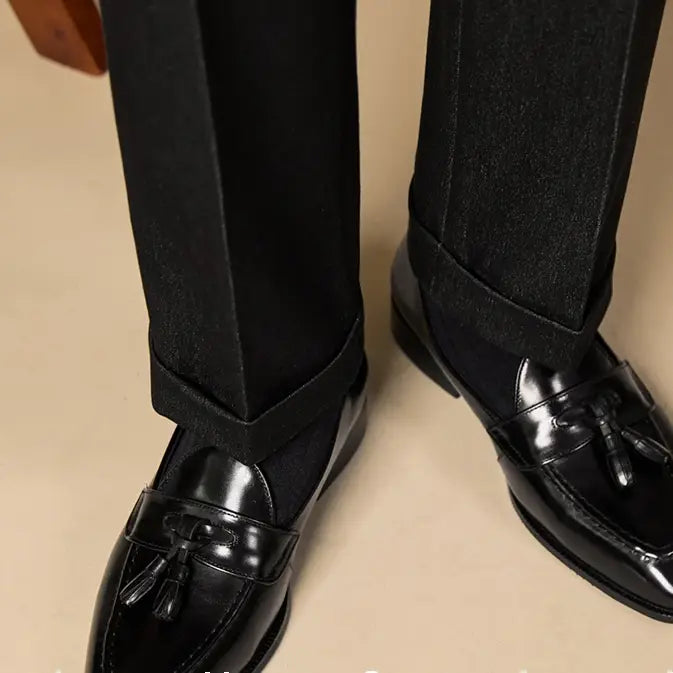 polished genuine leather tassel loafers in black patent leather with a glossy finish and classic design