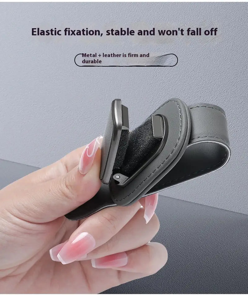 Black leather and metal car phone holder with elastic fixation designed as a pu leather case for glasses clip holder.