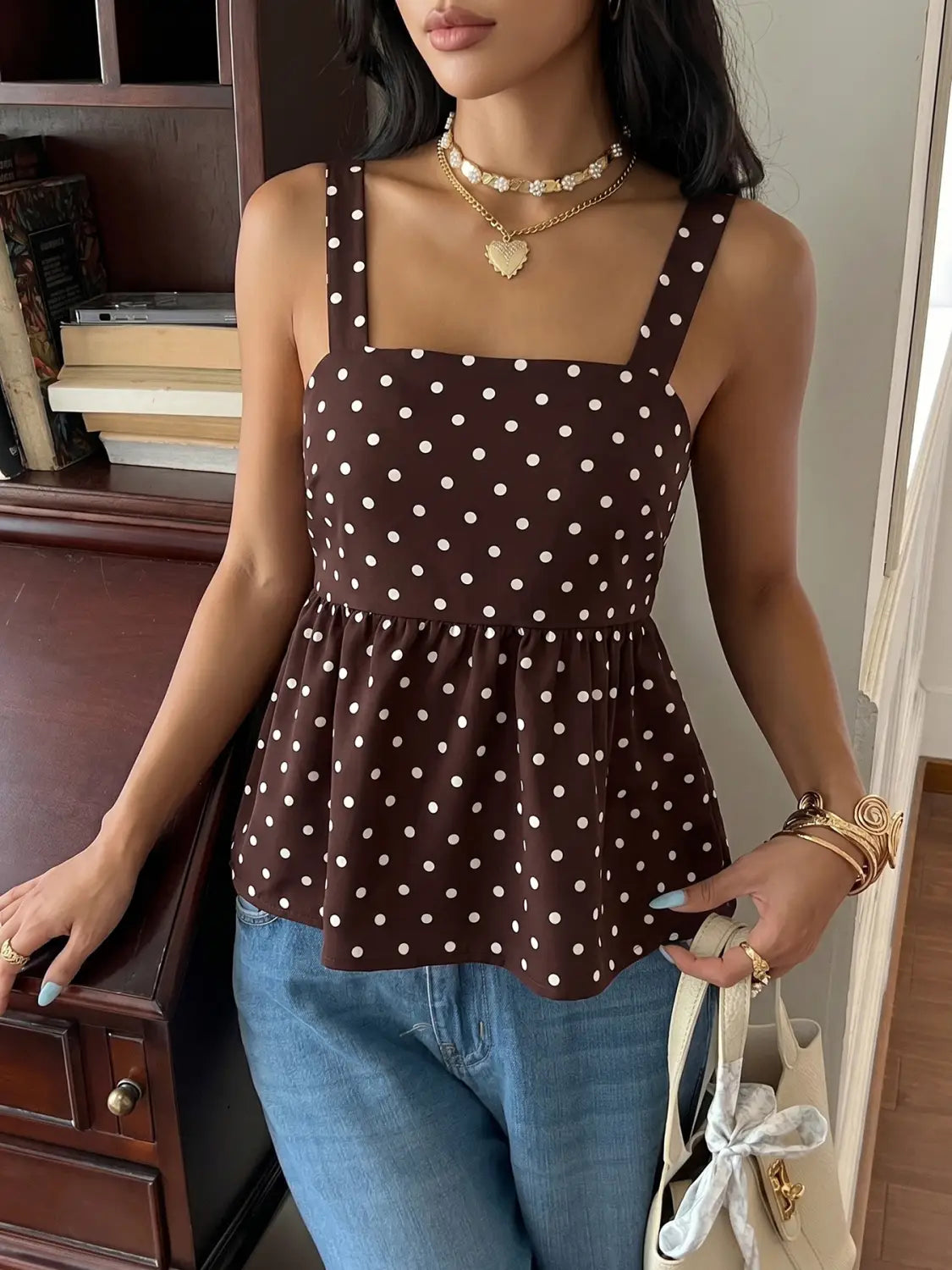 Brown polka dot peplum camisole with white dots and thin straps in lightweight fabric for casual wear.