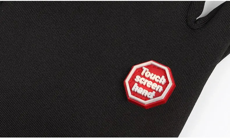 red octagonal patch with white touch screen hand text sewn onto the back side of usb heated cycling gloves made of black textured fabric designed for windproof warm use.