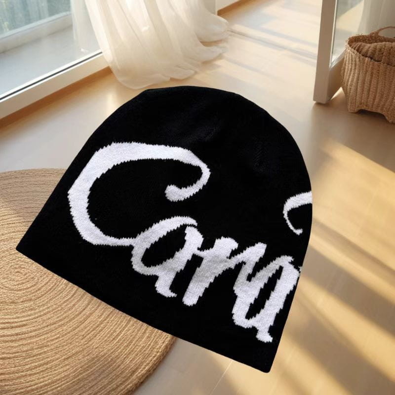 Black knitted embroidered letter knit beanie hat featuring a bold white carry logo in cursive script