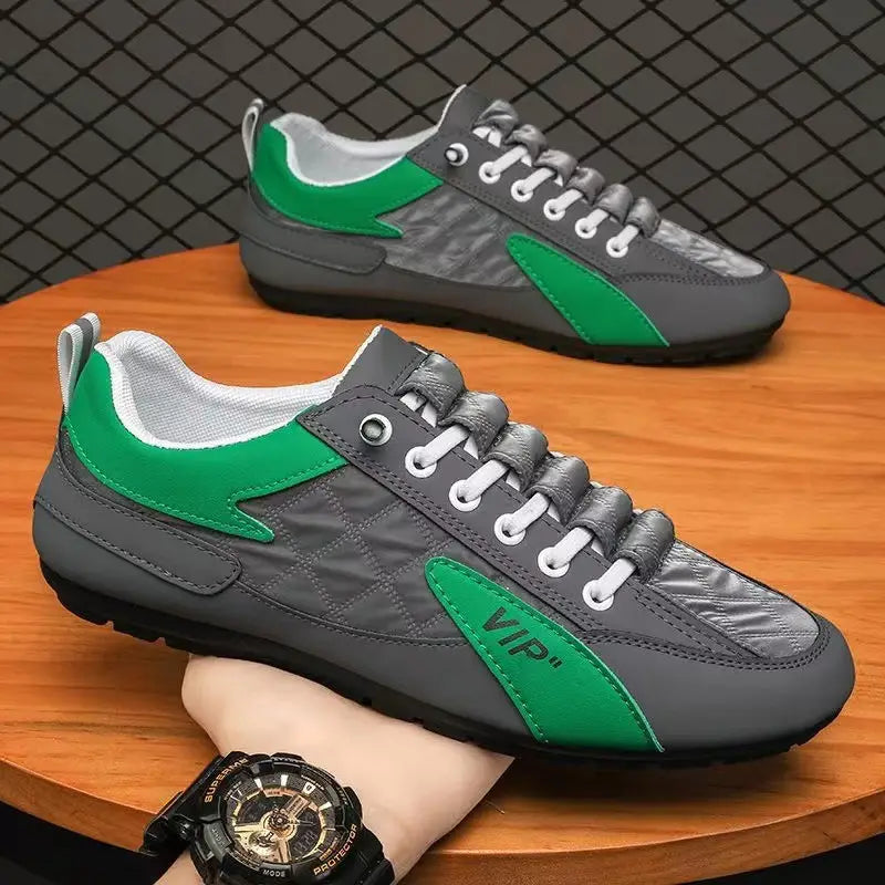 Men’s low top quilted athletic fashion sneakers in gray and green with quilted panels white laces and a vip logo on the side.