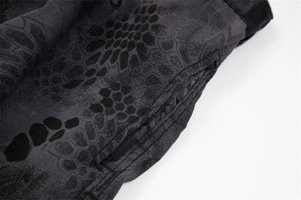 black fabric shorts with a subtle textured snake-scale pattern shown from the back, designed as camouflage cargo pants wide leg tactical trousers.