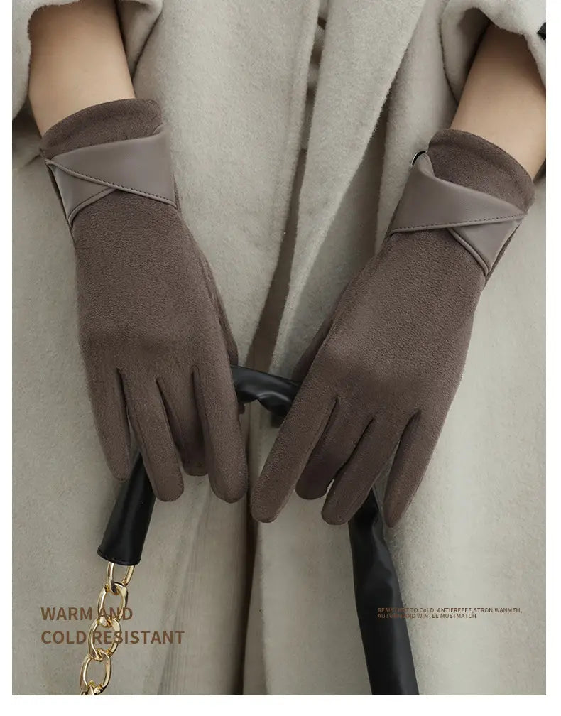 Touchscreen fleece lined bow gloves in brown suede with a contrasting gray panel across the wrist and black leather accents shown from the back side.