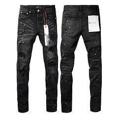 men’s distressed slim fit patchwork denim jeans in black featuring silver studs and a white tag on the back pocket shown from the back side
