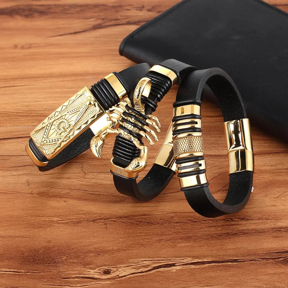 Black leather bracelet featuring gold-tone scorpion and rectangular plate accents with a gold magnetic clasp.