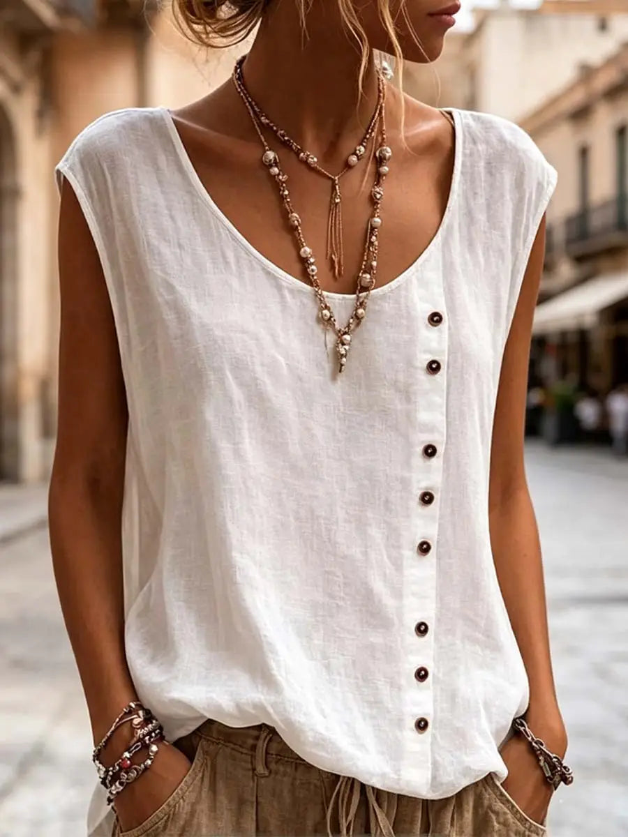 White sleeveless vest with relaxed fit and dark buttons down the front featuring a subtle textured fabric for casual wear.