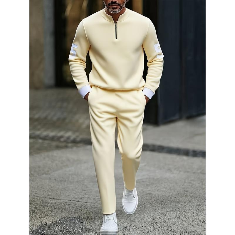Cream-colored full-zip sweatshirt with white cuffs and subtle patch details on the sleeves from the half zip athletic sweatsuit printed set.