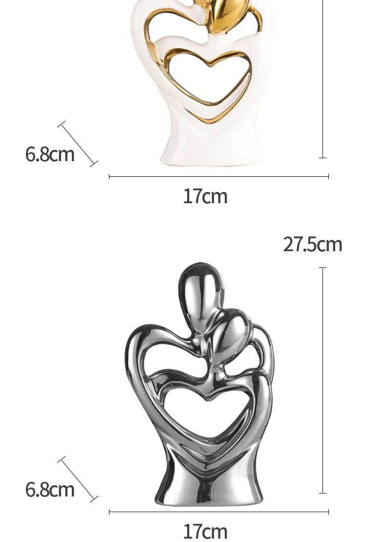 White ceramic and gold-accented abstract couple figurine with heart-shaped cutouts for modern home decor.
