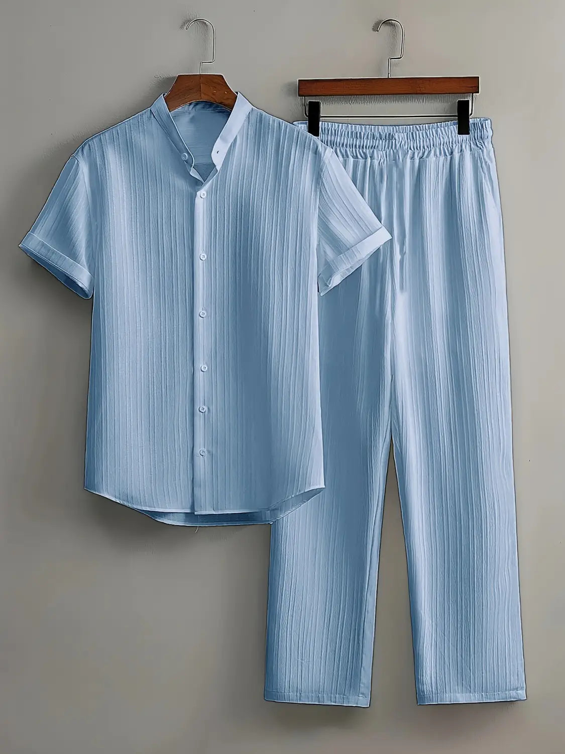 Light blue striped mens pleated short sleeve shirt and pants set featuring a button-up shirt and matching pants in a soft fabric ideal for comfortable wear.