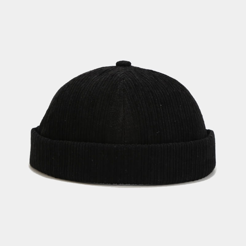 Black corduroy landlord beanie with ribbed texture and folded brim designed as an adjustable streetwear hat.
