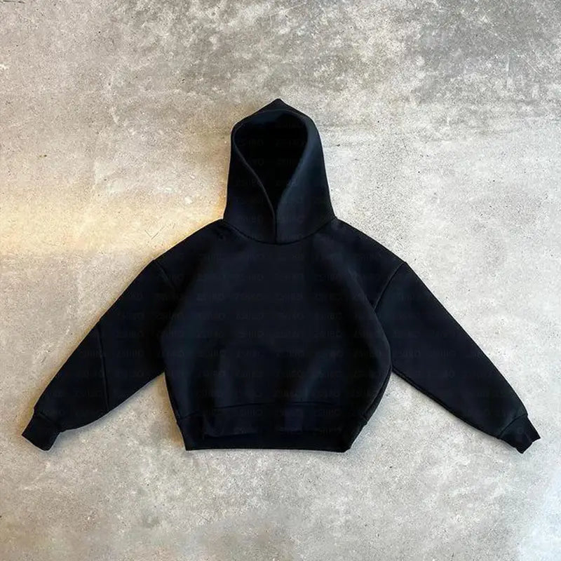 Sweat à capuche oversize unisexe streetwear noir, à coupe ample et décontractée, avec poignets côtelés.