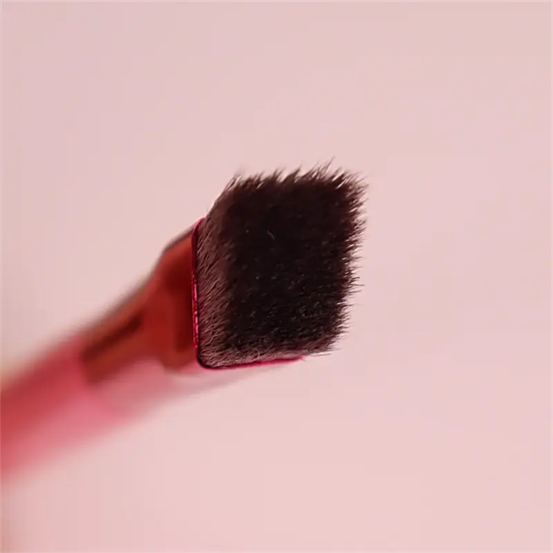 a red-handled angled eyebrow and concealer makeup brush with dense dark black bristles forming a square tip from a set of 500 pieces