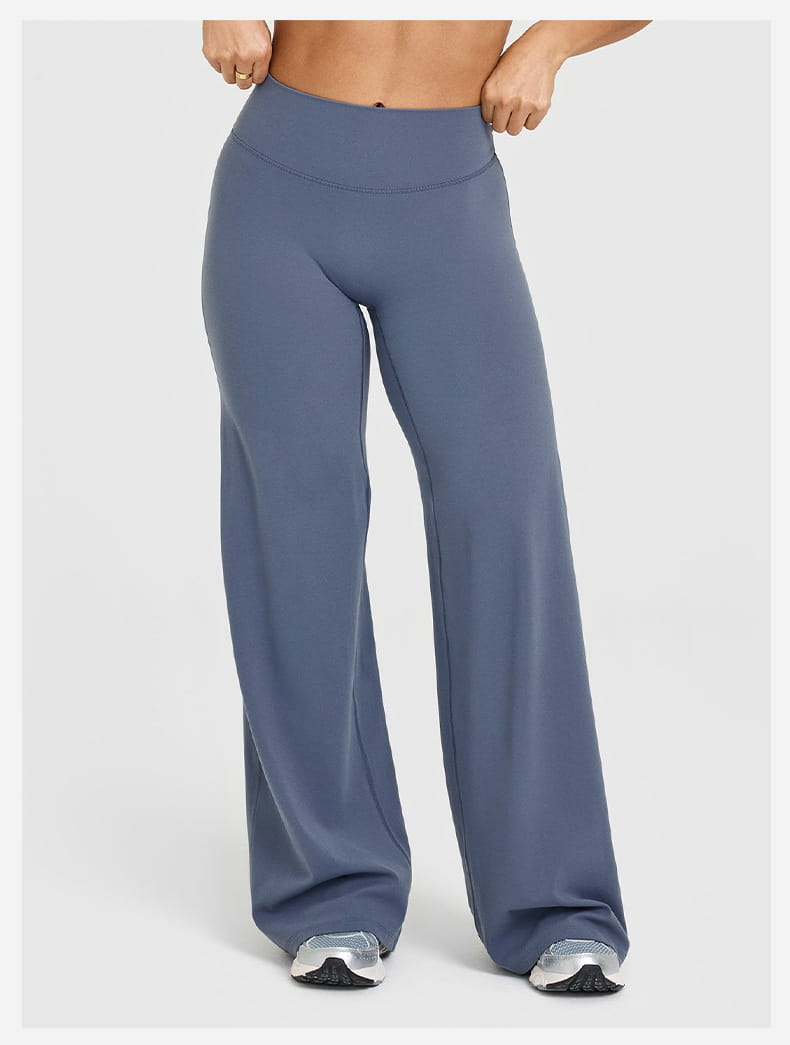 Blue high-waisted slimming yoga pants with a straight leg design made of stretchy smooth fabric