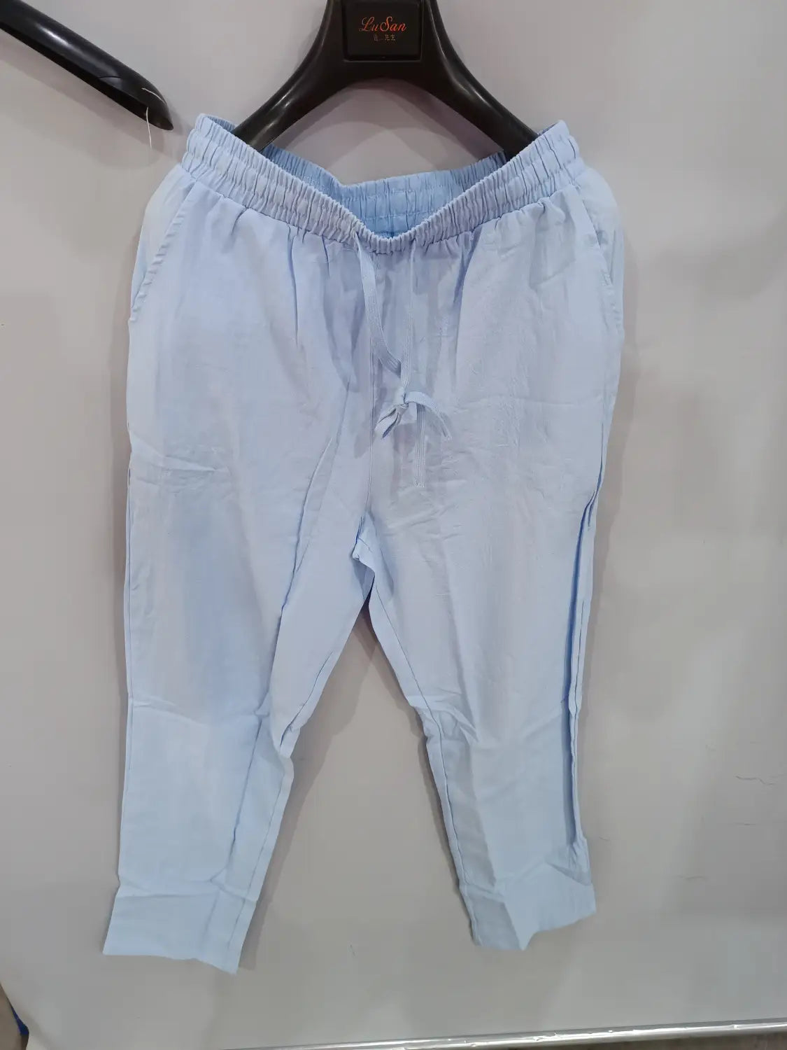 men’s linen joggers casual drawstring pants in light blue cotton with an elastic waistband and drawstring closure.