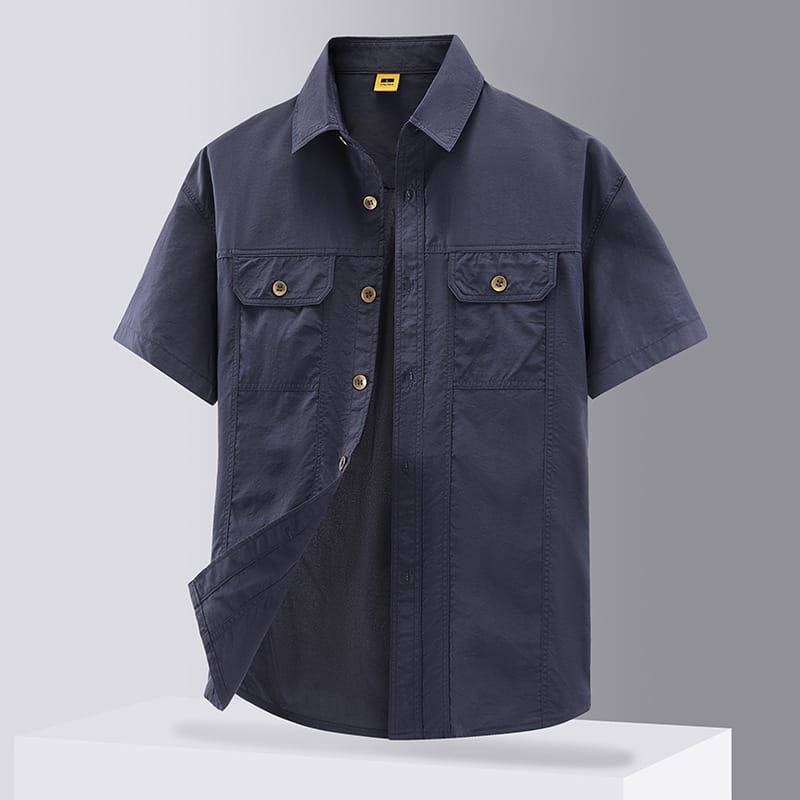 Dark navy men solid workwear short sleeve shirt with two front chest pockets and brass colored buttons.