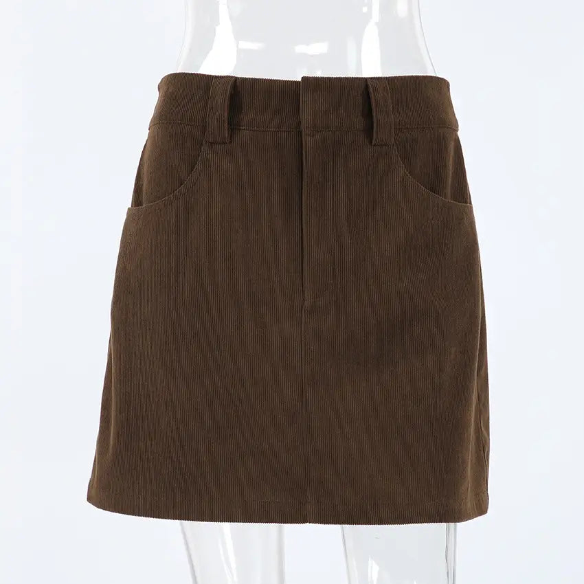 Brown corduroy mini skirt featuring a straight hem and front pockets with a matching belt for a retro look.