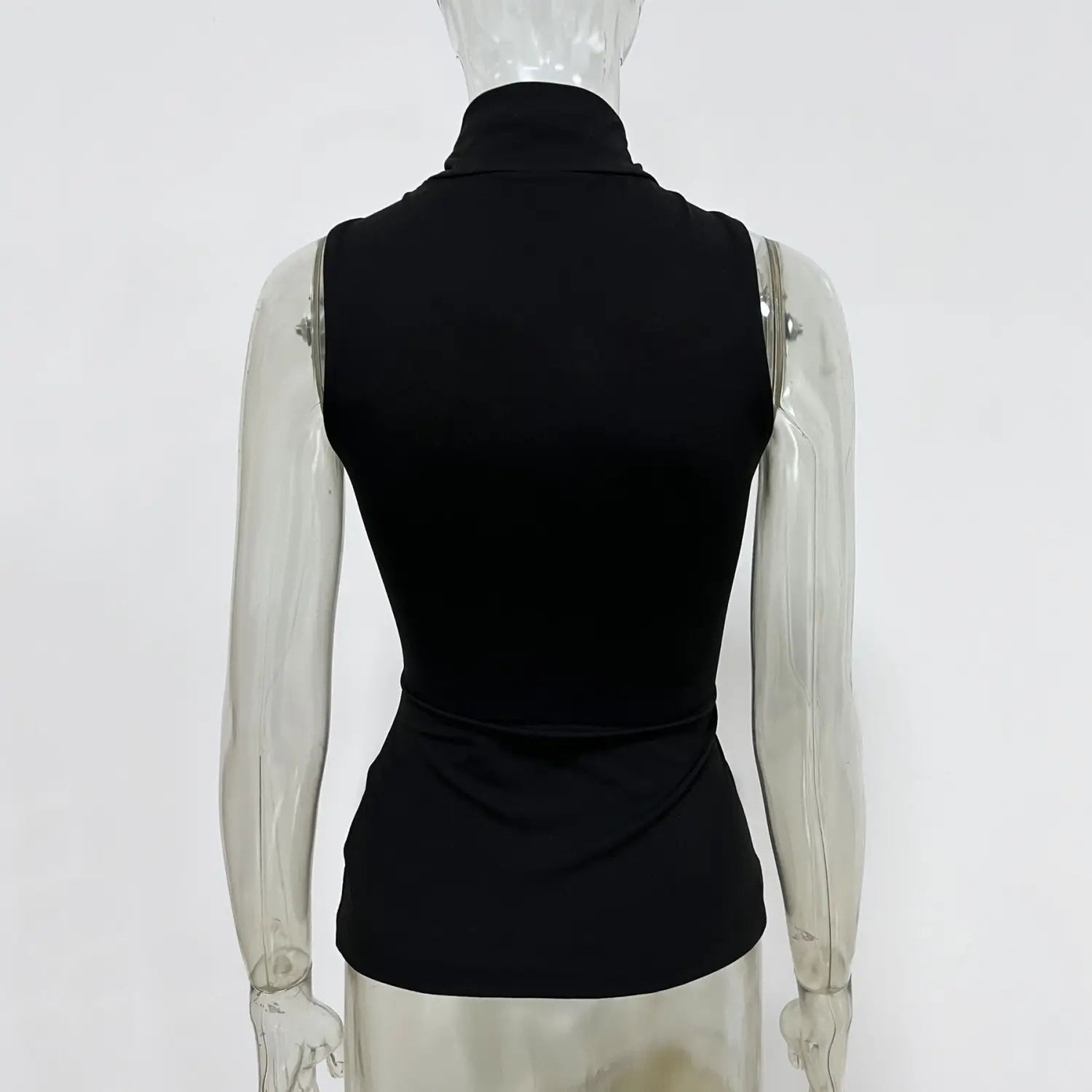 Black sleeveless gold ring halter stretch top with a fitted silhouette and subtle ruching at the waist.