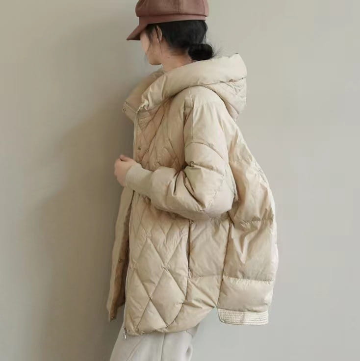 Beige quilted white duck down puffer jacket with a loose hood and subtle diamond stitching for winter wear.
