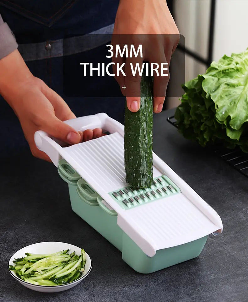 Vegetable slicer mandoline grater made of light green and white plastic with 3mm thick wire blades for slicing vegetables.