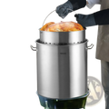84qt stainless steel stockpot with strainer basket featuring perforated lid and handles with large roasted chicken inside