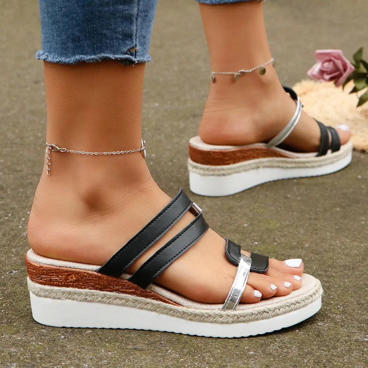 Black and silver wedge sandals with espadrille woven rope sole and metal accents.