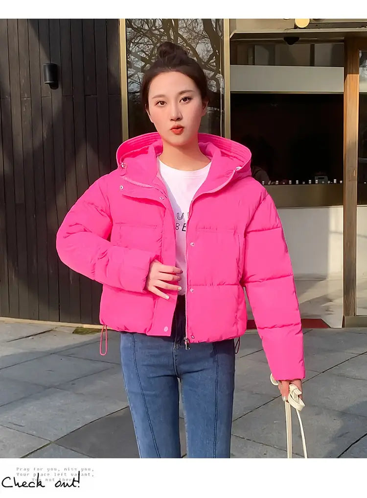 Bright pink women hooded short down jacket with a front zipper and insulated puffer material designed for warmth.