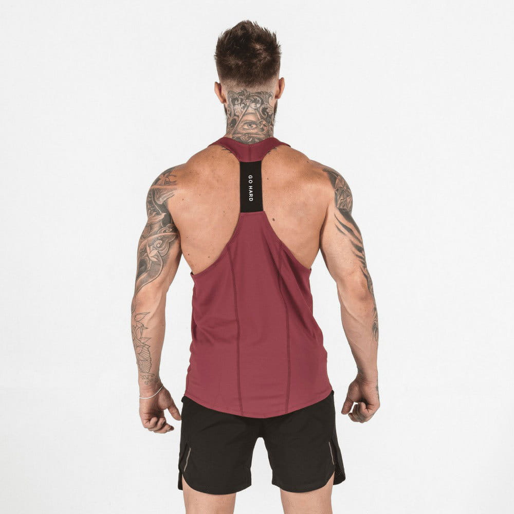Men’s go hard racerback athletic tank top in maroon with a black back panel featuring go hard branding.