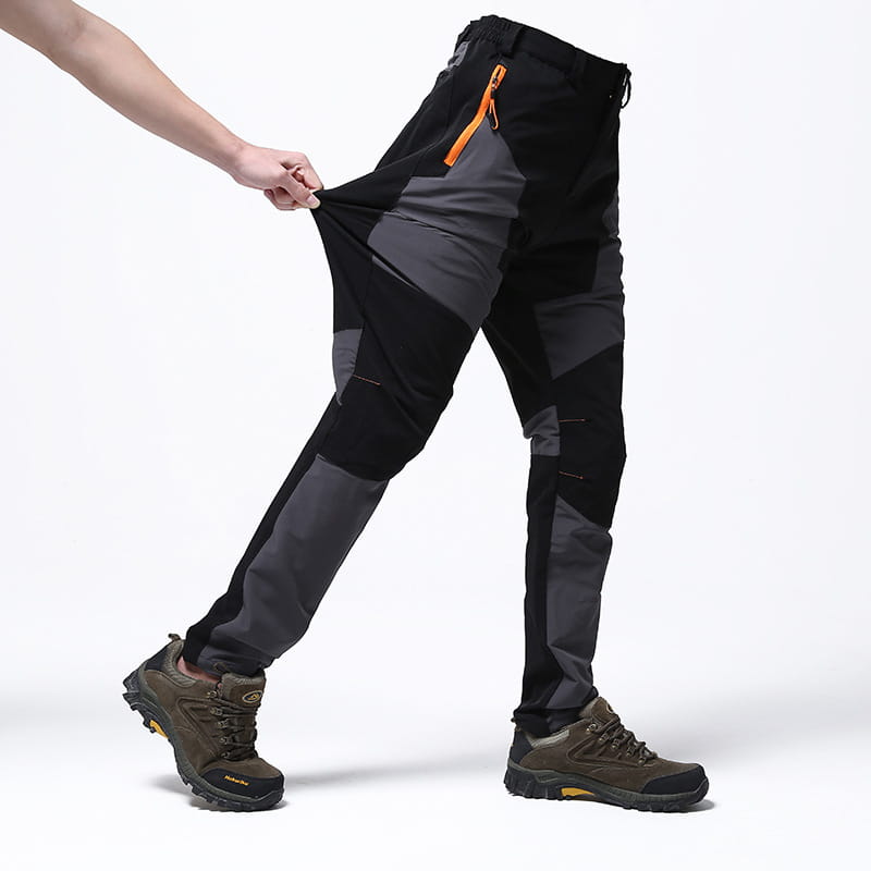 Men waterproof hiking pants in black and gray with orange zipper accents designed for tactical use and stretch comfort.