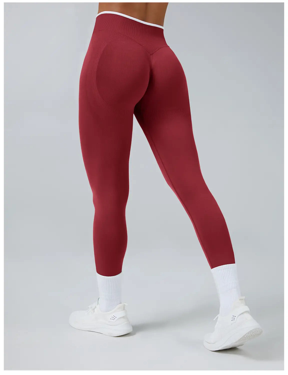 Seamless high waist sports yoga leggings in red with a white trim at the waistband designed for comfort and flexibility.