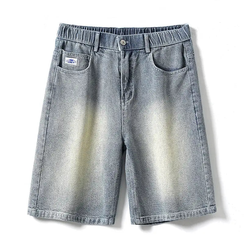 Men’s elastic waist light wash denim shorts with a faded gradient effect from dark blue at the waist to lighter beige near the hem featuring an elasticated waistband and front pockets.