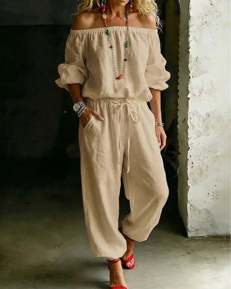 Beige linen off-shoulder jumpsuit set with drawstring waist and loose tapered legs.