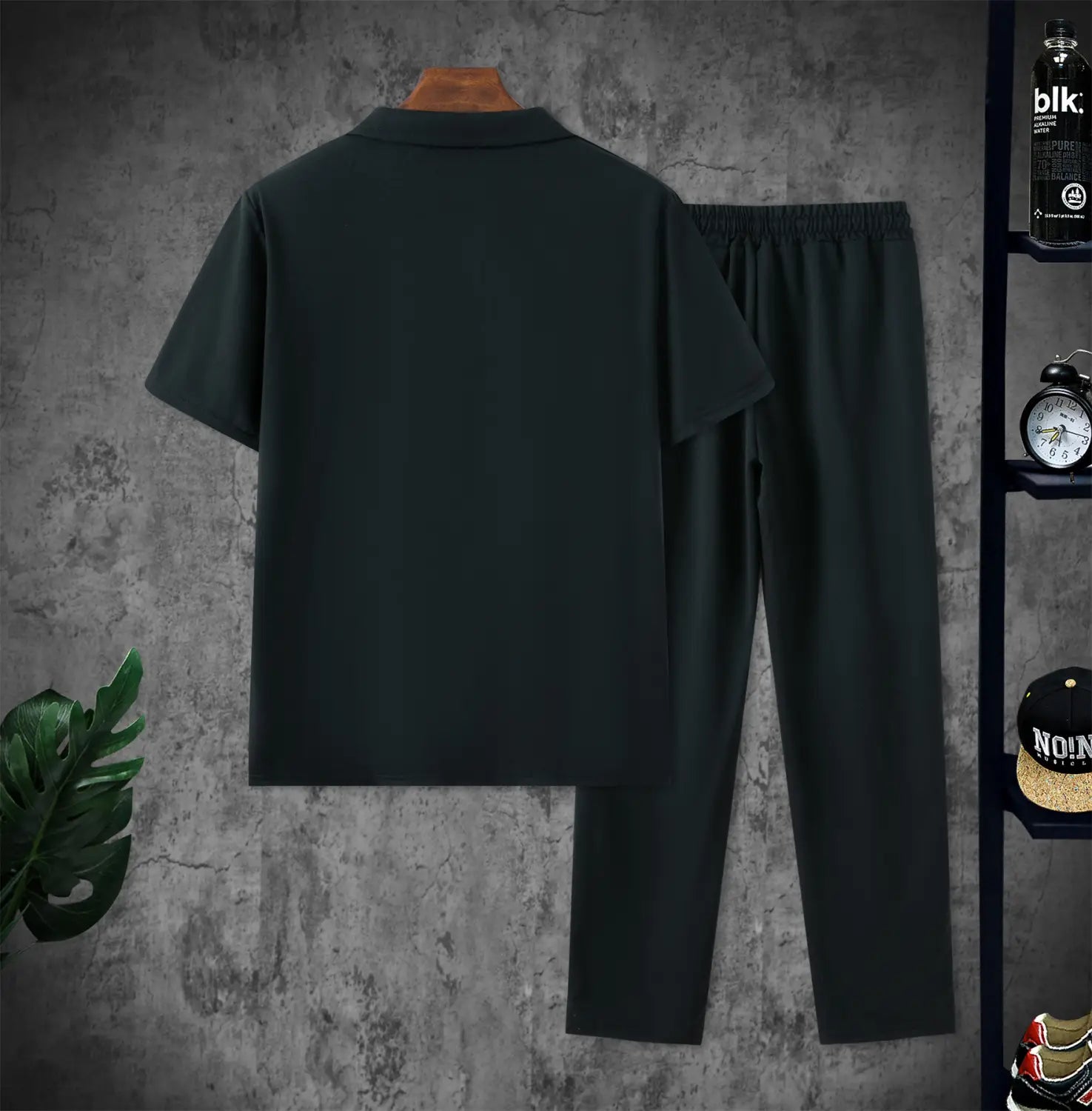 men short sleeve polo shirt and pants set in black cotton fabric displaying the front design