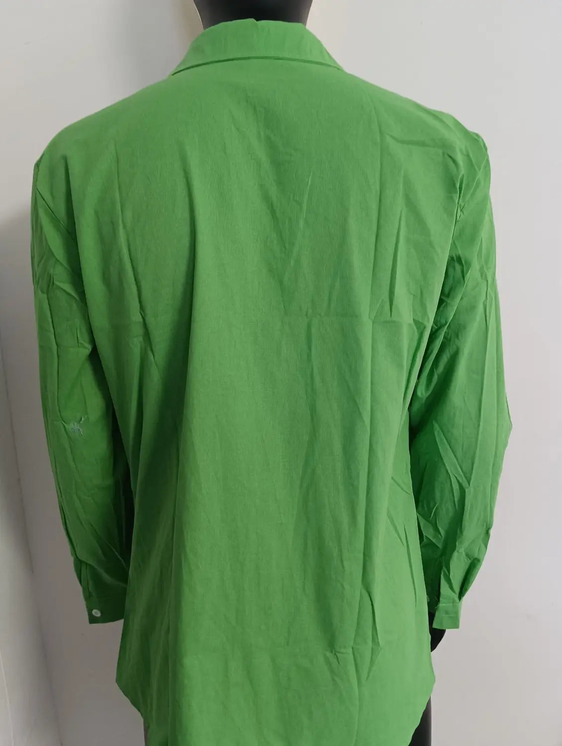 A vibrant green mens cotton long sleeve casual button down shirt with a classic collar and neatly pressed fabric.