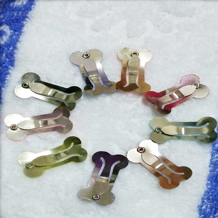 Shiny metallic bone shaped underwire dog hair clips in assorted colors including gold silver rose gold and purple made of metal for pet barrettes.