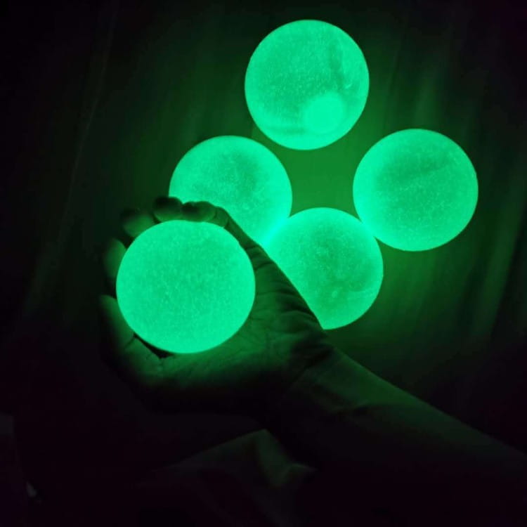 glowing green sticky wall ball stress relief toys with a textured matte finish designed for squashing and stress relief.