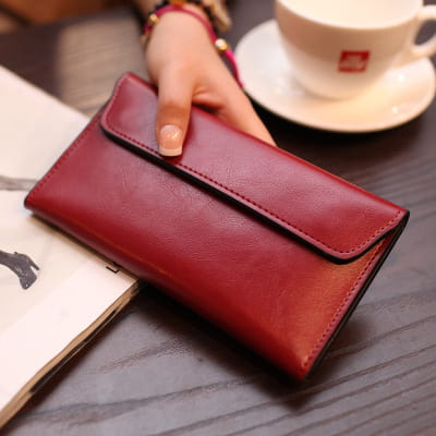 A rich burgundy retro slim cowhide leather flap wallet with contrast stitching and a sleek minimalist design.