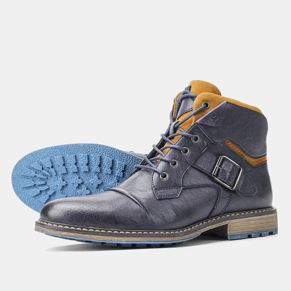 Men’s leather martin boot with dark blue leather, tan suede accents, silver buckle, and blue rubber sole.