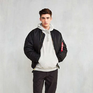 Men’s pilot cotton bomber jacket in black featuring a red patch on the sleeve shown from the back side.