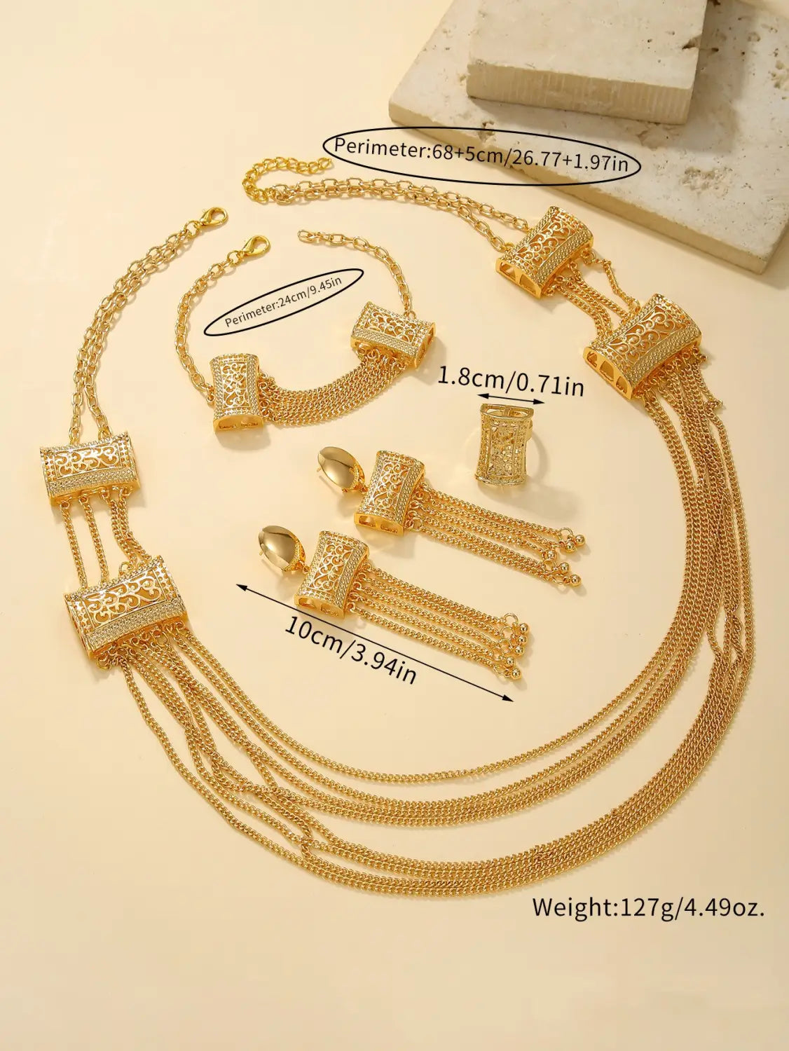 Gold layered tassel necklace and jewelry set featuring a gold-toned multi-strand design with intricately detailed rectangular pendants and dangling chains.