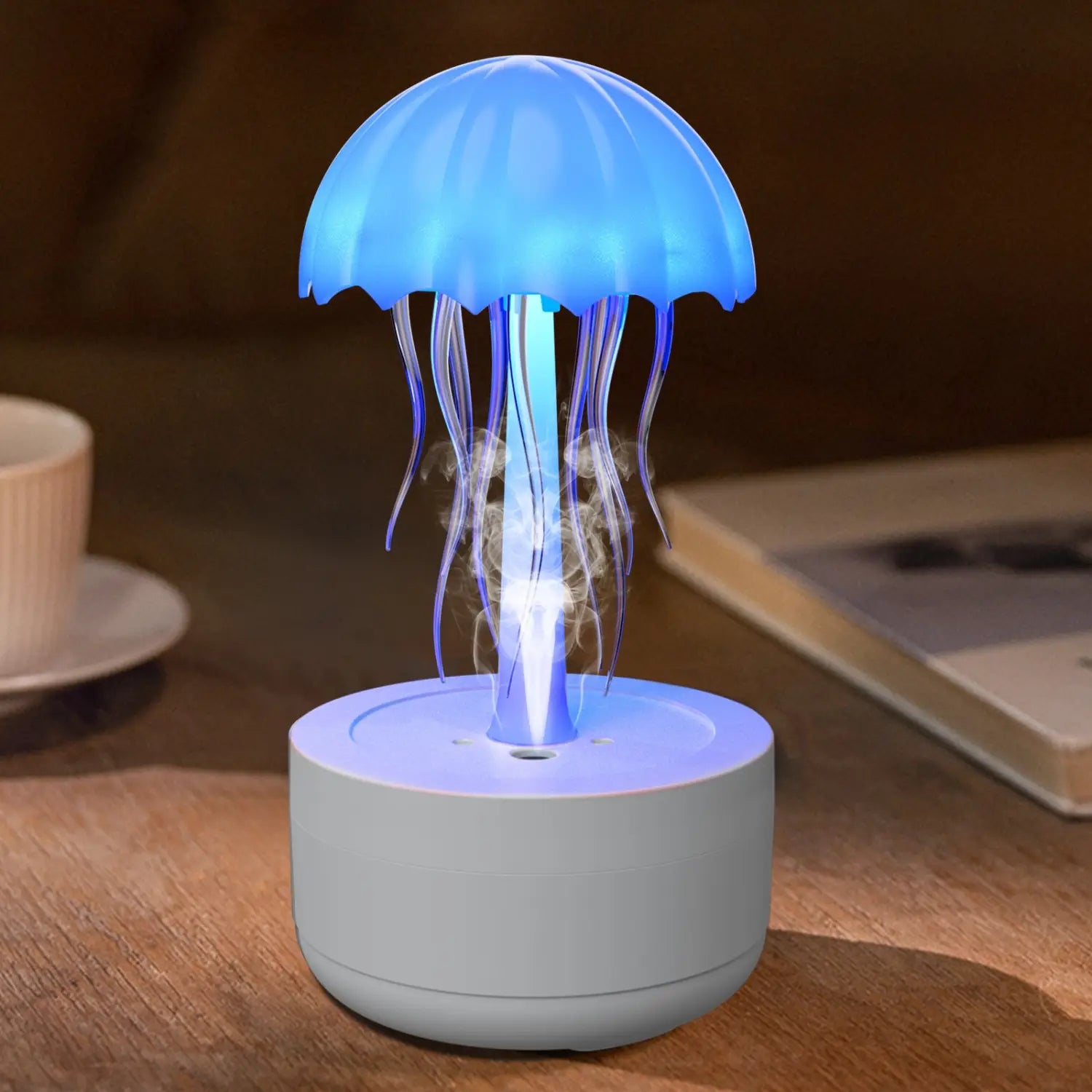 blue glowing jellyfish-shaped led lamp with translucent tentacles and a white cylindrical base designed as a humidifier and essential oil diffuser with 7 color led options