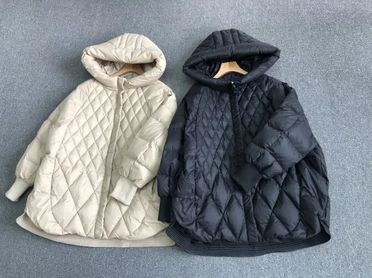 two white duck down puffer jackets in cream and black with diamond-stitched pattern and hoods designed for loose winter wear