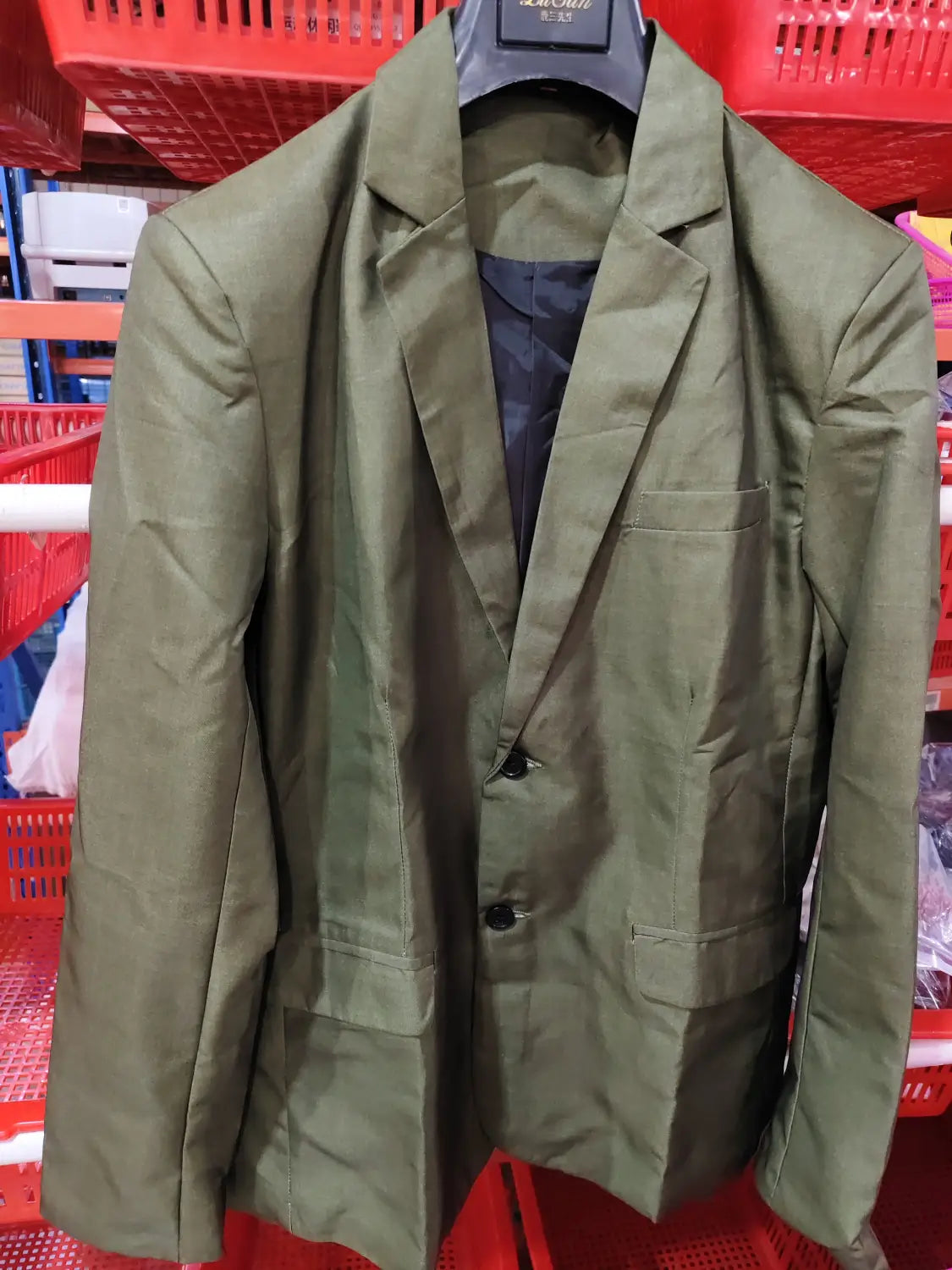 Men plaid blazer slim fit british style jacket in olive green with black buttons and dark inner lining hanging on a hanger