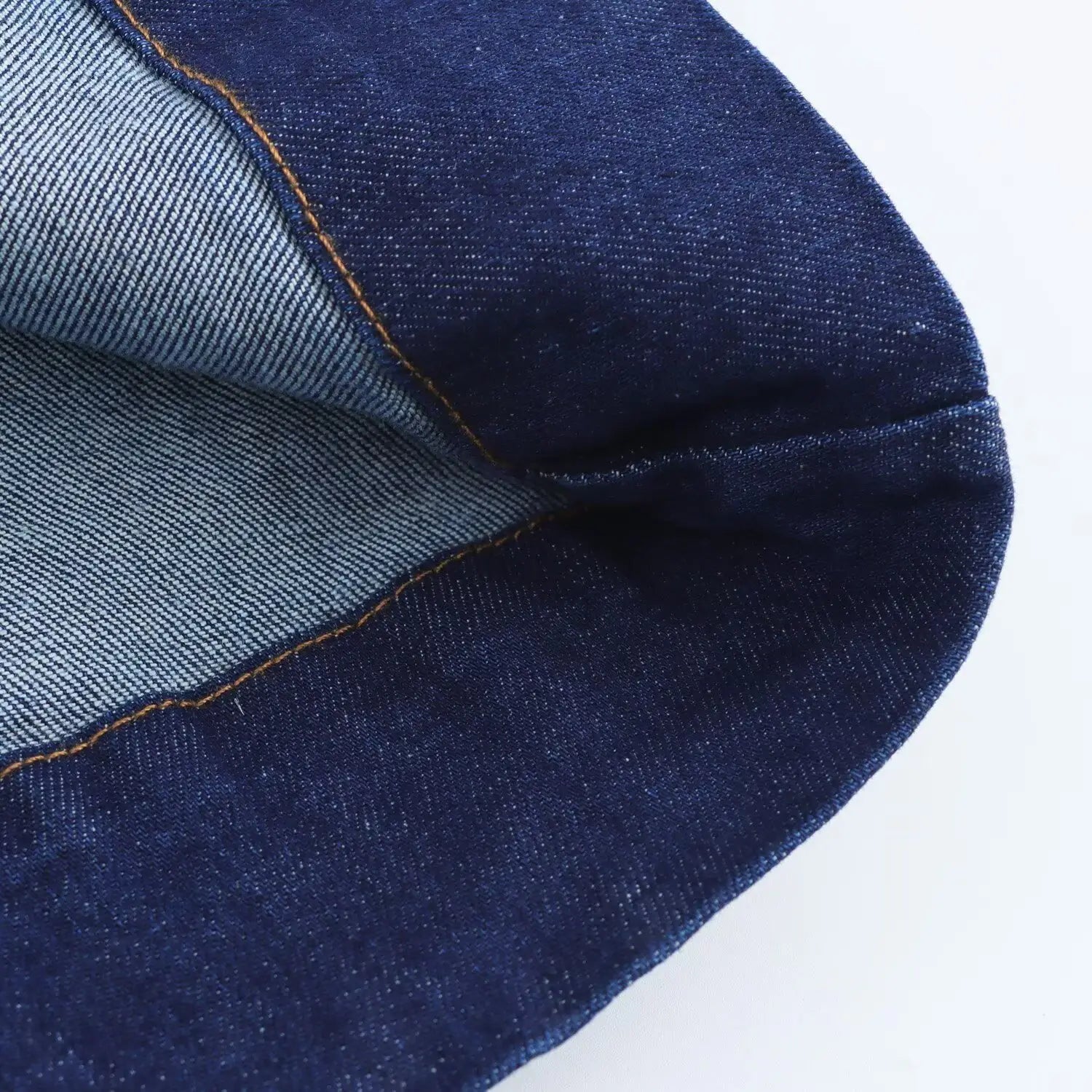 Navy crew neck sleeveless denim a-line dress featuring dark blue denim fabric with visible stitching and lighter inner lining.